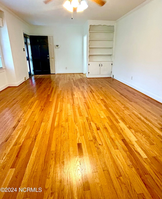 unfurnished living room with crown molding, ceiling fan, and light hardwood / wood-style floors