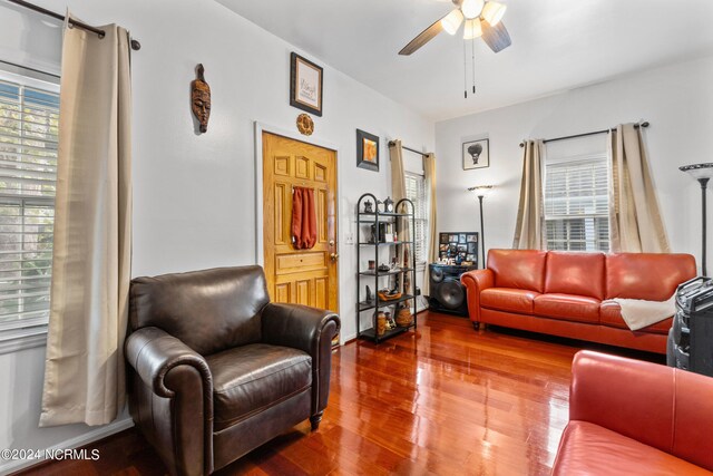 living area featuring plenty of natural light, a ceiling fan, and wood finished floors