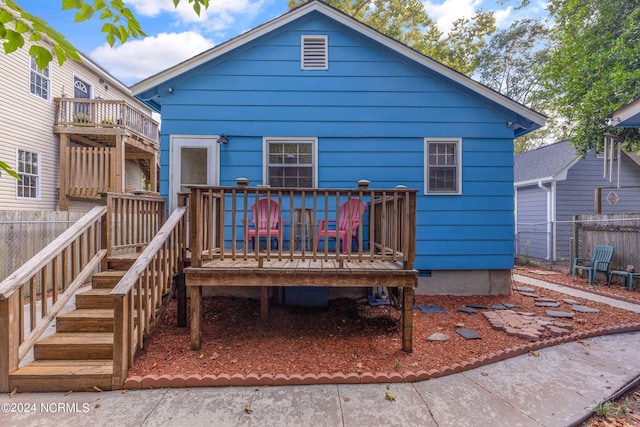 view of front facade featuring a deck and fence