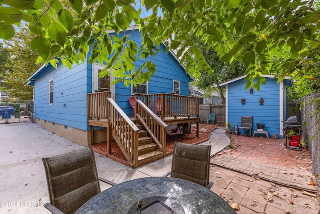 rear view of house with a patio area and a wooden deck