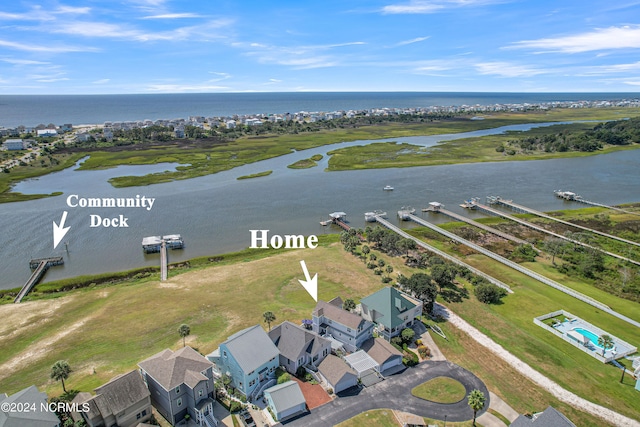 birds eye view of property with a water view