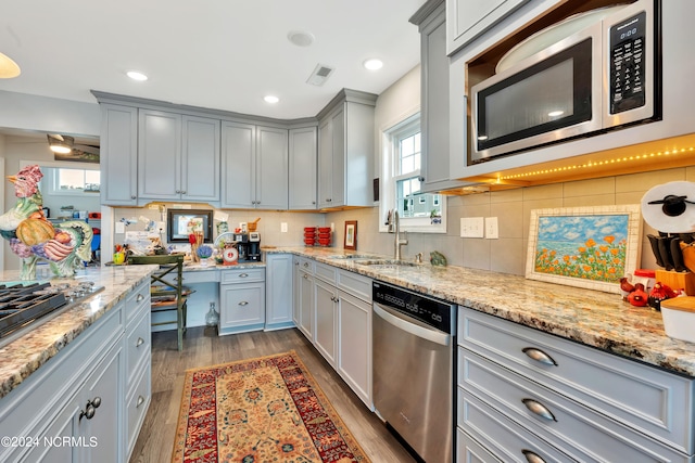 kitchen featuring backsplash, dark hardwood / wood-style floors, sink, and stainless steel appliances