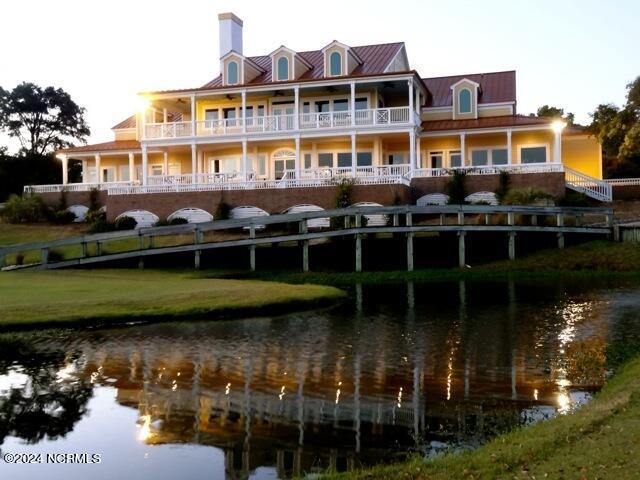 exterior space with a water view and a balcony