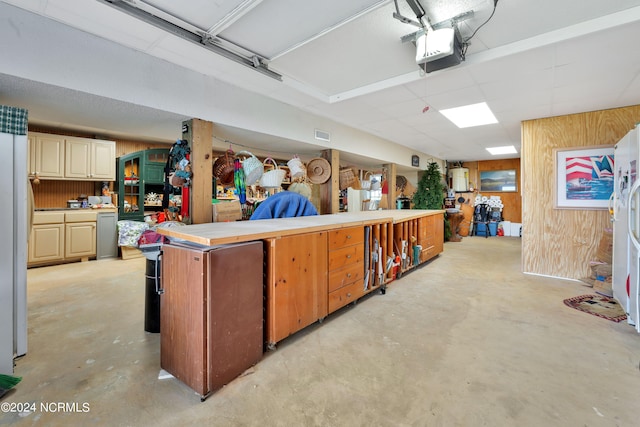 interior space featuring wood walls and a garage door opener