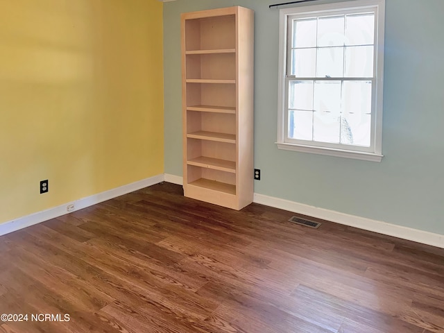 empty room featuring dark wood-type flooring