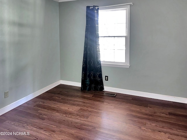 spare room with dark hardwood / wood-style floors