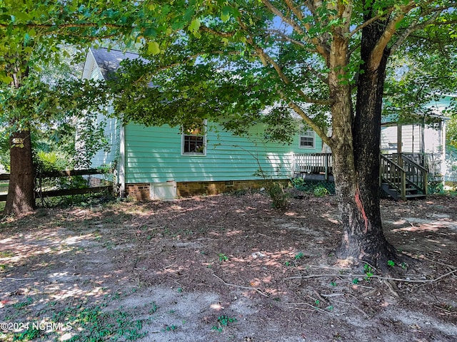 view of property exterior with a wooden deck