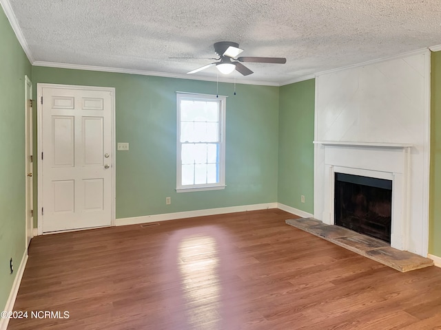 unfurnished living room with ceiling fan, ornamental molding, wood-type flooring, and a textured ceiling