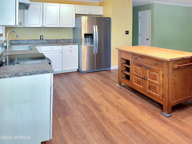 kitchen with stainless steel refrigerator with ice dispenser, white cabinetry, ornamental molding, and light hardwood / wood-style floors