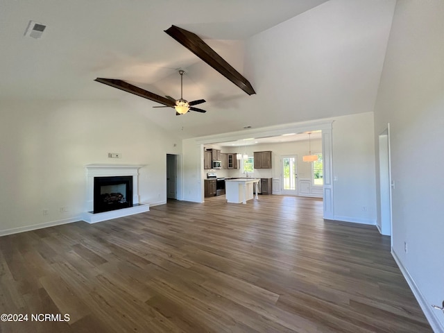 unfurnished living room featuring beam ceiling, dark hardwood / wood-style floors, ceiling fan, and high vaulted ceiling