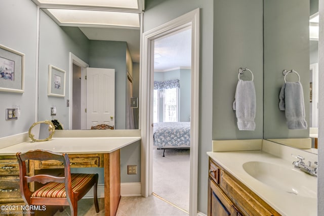 bathroom with vanity, ornamental molding, and tile patterned floors