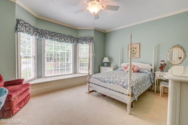 carpeted bedroom featuring a textured ceiling, ceiling fan, and crown molding