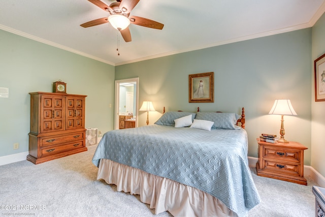 carpeted bedroom with ceiling fan, crown molding, and ensuite bathroom