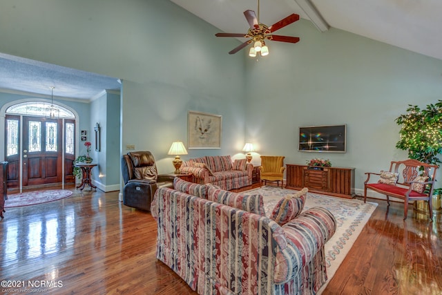 living room featuring ceiling fan with notable chandelier, high vaulted ceiling, beamed ceiling, and hardwood / wood-style flooring