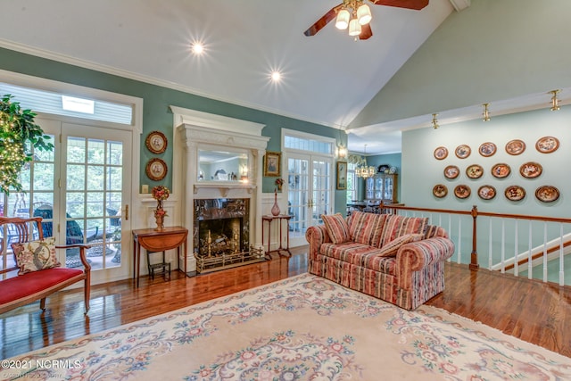 living room featuring ceiling fan, hardwood / wood-style flooring, and crown molding