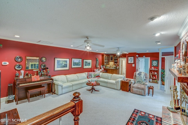 carpeted living room with ceiling fan, a textured ceiling, and ornamental molding