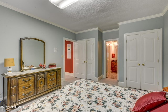 carpeted bedroom with ornamental molding and a textured ceiling