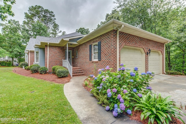 view of front of house with a front yard and a garage