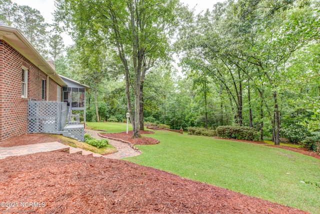 view of yard featuring a sunroom