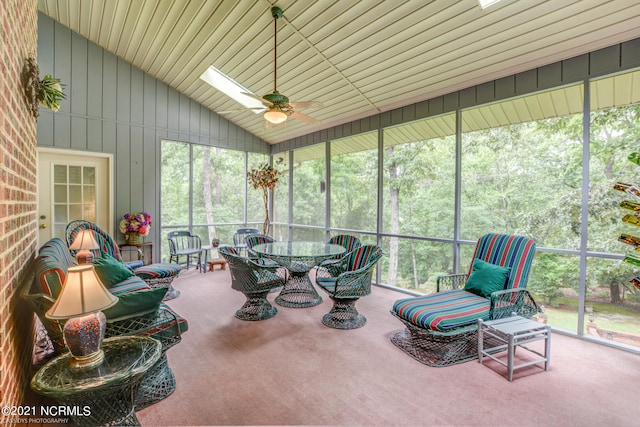 sunroom / solarium with ceiling fan, vaulted ceiling, and a wealth of natural light