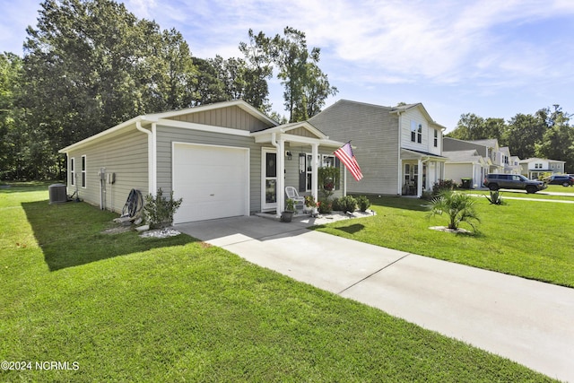 view of front facade with board and batten siding, a front yard, driveway, and a garage