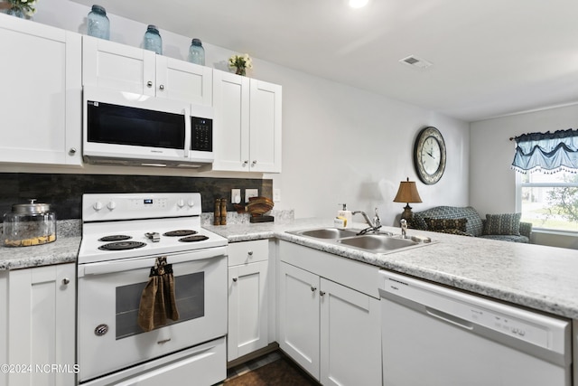 kitchen featuring white appliances, a sink, visible vents, white cabinets, and light countertops