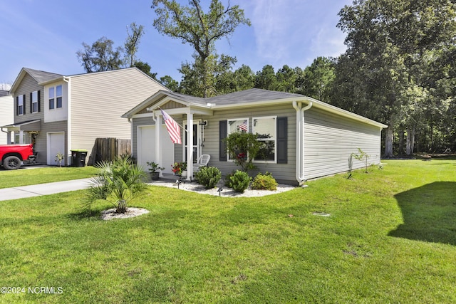 view of front of home featuring a garage, a front yard, and driveway