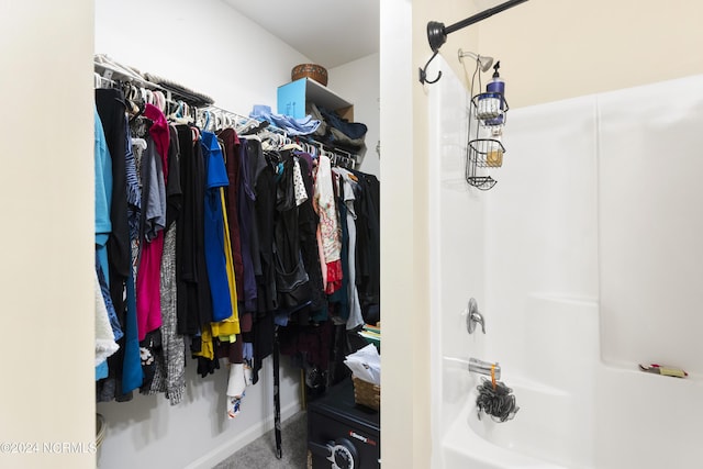 walk in closet with carpet floors