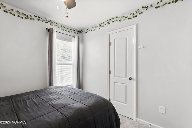 carpeted bedroom with a ceiling fan and baseboards