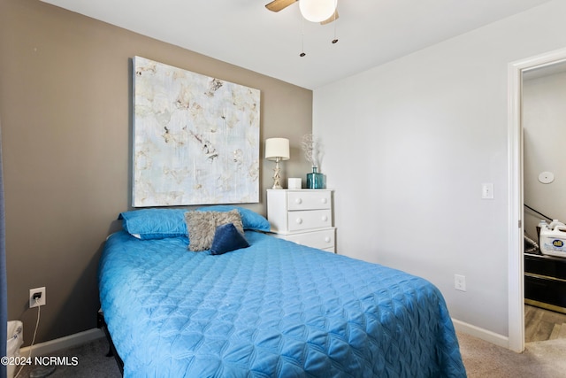 carpeted bedroom with baseboards and a ceiling fan