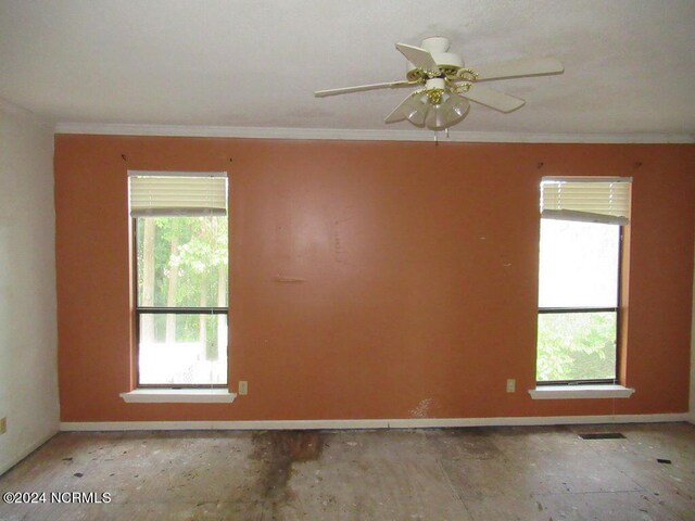 unfurnished room featuring ceiling fan and crown molding