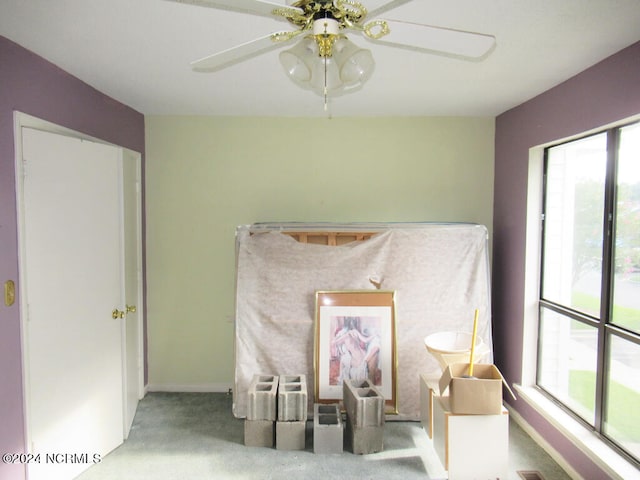 interior details with ceiling fan and carpet flooring