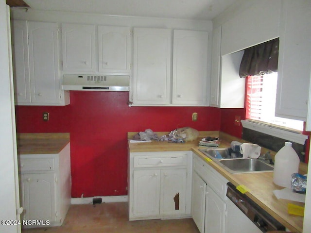 kitchen with white cabinets, white dishwasher, and sink