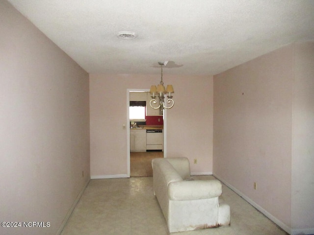 unfurnished room with a notable chandelier and sink