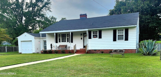 view of front of house with covered porch, a front yard, and a garage