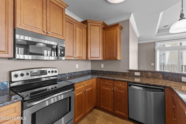 kitchen featuring pendant lighting, crown molding, stainless steel appliances, dark stone counters, and light tile patterned flooring