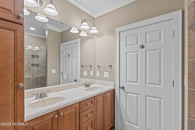 bathroom with crown molding, vanity, and a shower with shower door