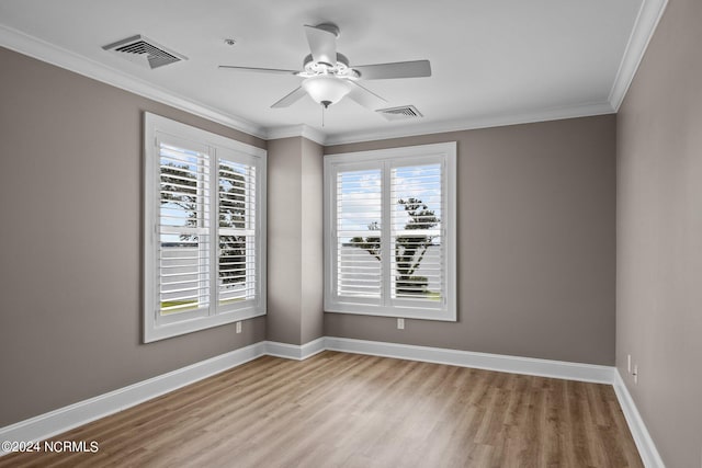 empty room with ceiling fan, ornamental molding, and wood-type flooring