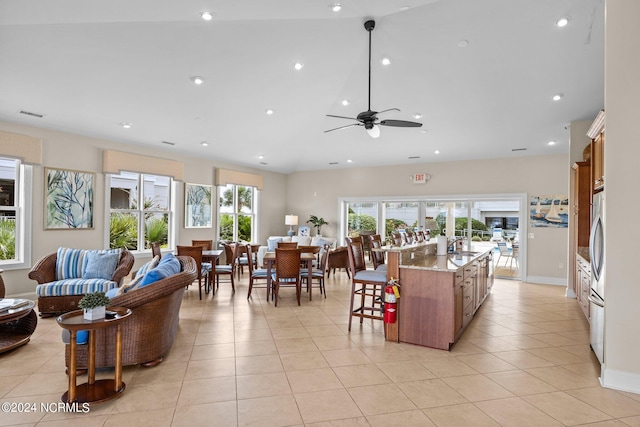 tiled living room with ceiling fan