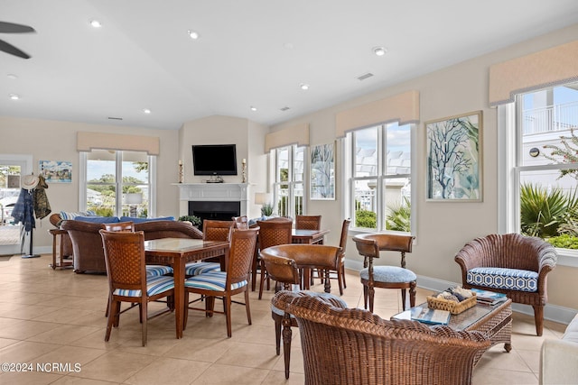 tiled dining space featuring vaulted ceiling