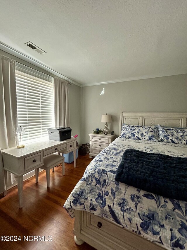 bedroom featuring dark wood-type flooring and a textured ceiling