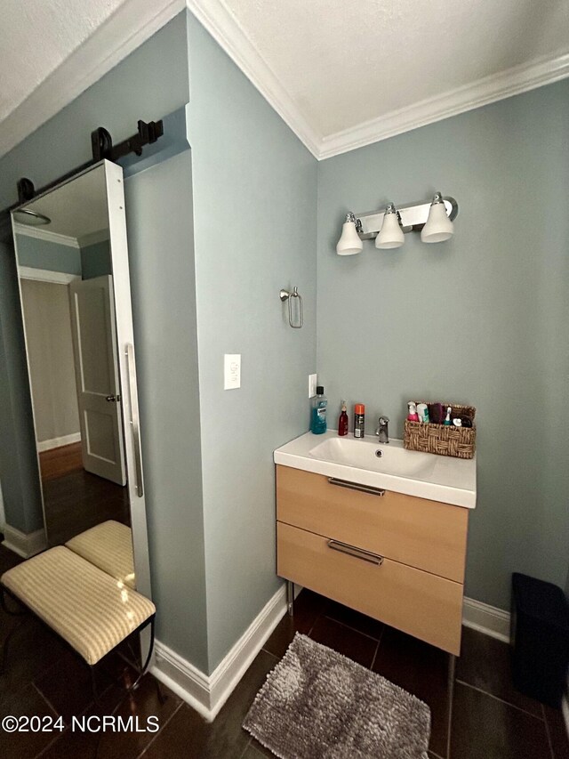 bathroom featuring vanity, ornamental molding, and wood-type flooring