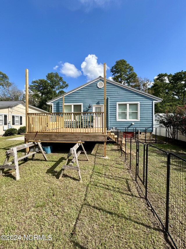 back of house with a yard and a deck