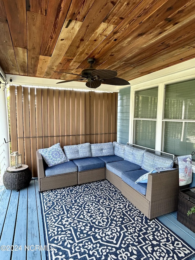 wooden terrace with an outdoor hangout area and ceiling fan