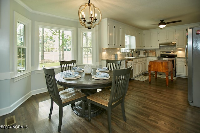 dining room with visible vents, baseboards, dark wood-style floors, an inviting chandelier, and crown molding