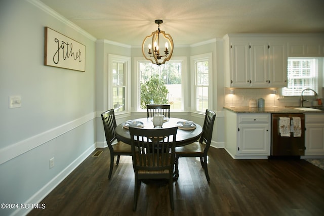 dining space featuring dark wood-style floors, a wealth of natural light, and crown molding