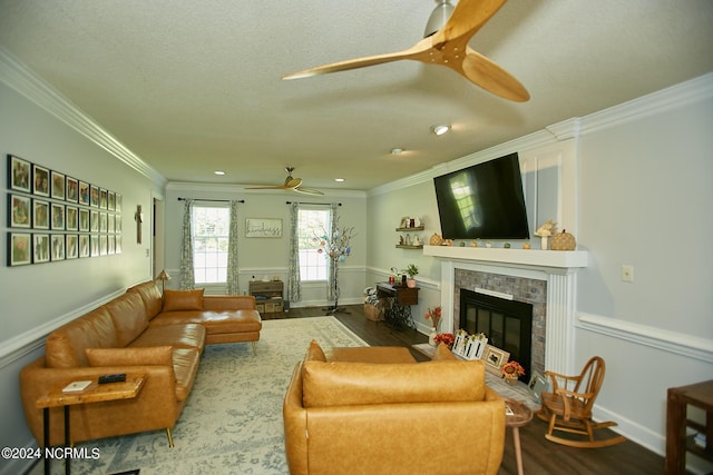 living area with ornamental molding, a fireplace with flush hearth, and dark wood finished floors