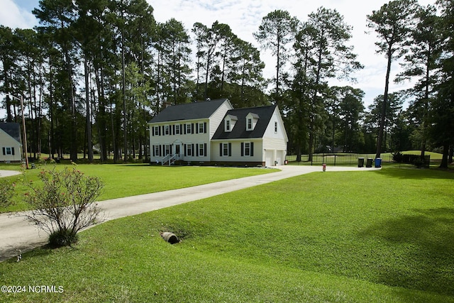 view of front of home with driveway, a garage, and a front yard