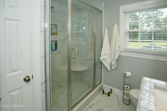 full bath featuring toilet, marble finish floor, a marble finish shower, and baseboards