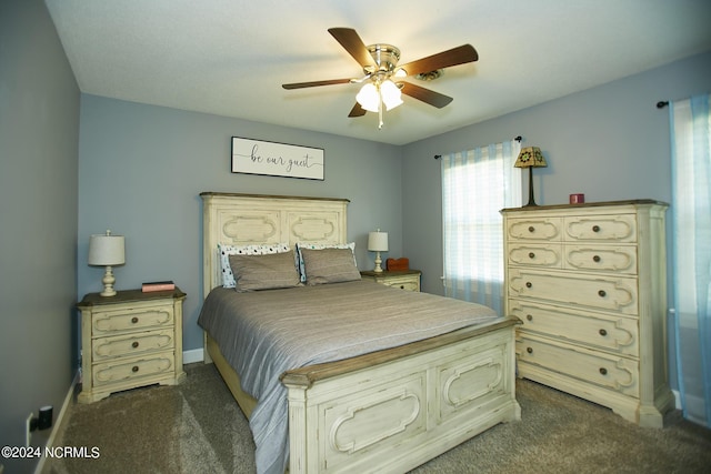 bedroom featuring ceiling fan, baseboards, and dark colored carpet